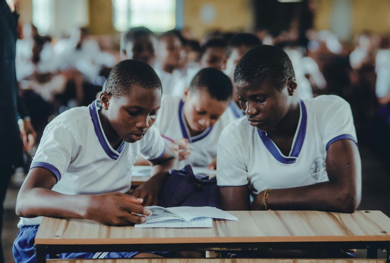 Two students studying with a textbook